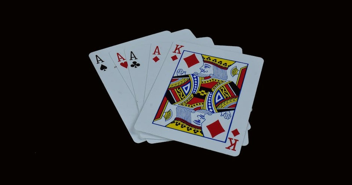 A striking image of four aces and a king on a black background, representing poker royalty.