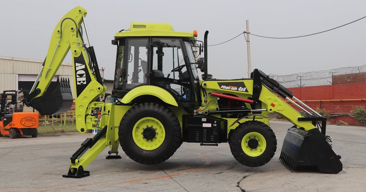 Image of ACE Phantom 4x4 backhoe loader parked on an outdoor construction site in India.