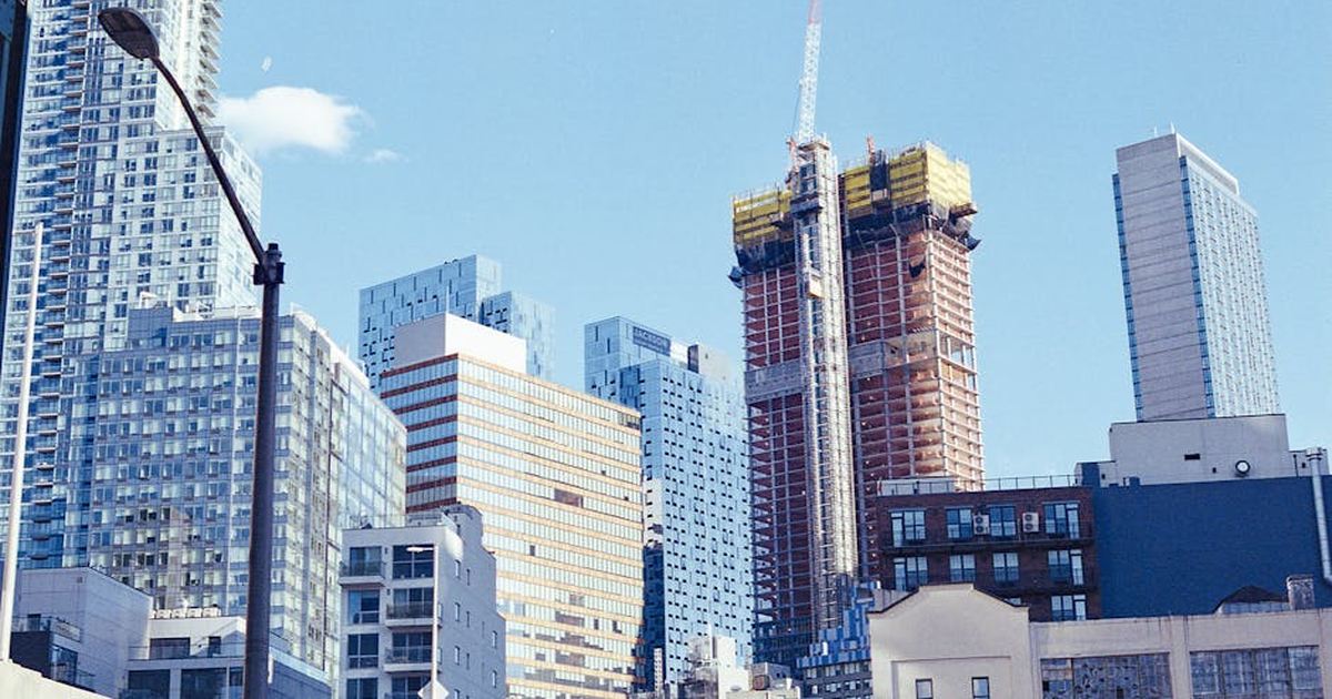 Bright and vibrant view of New York City's modern skyscrapers under a blue sky.