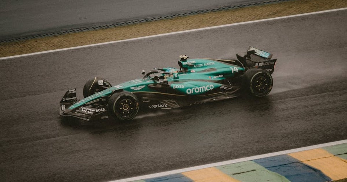 A Formula 1 car racing on a rain-soaked track, showcasing speed and precision.