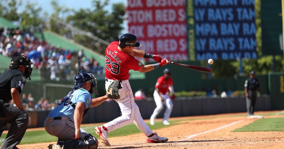 Action-packed baseball game in Santo Domingo, capturing a powerful swing.