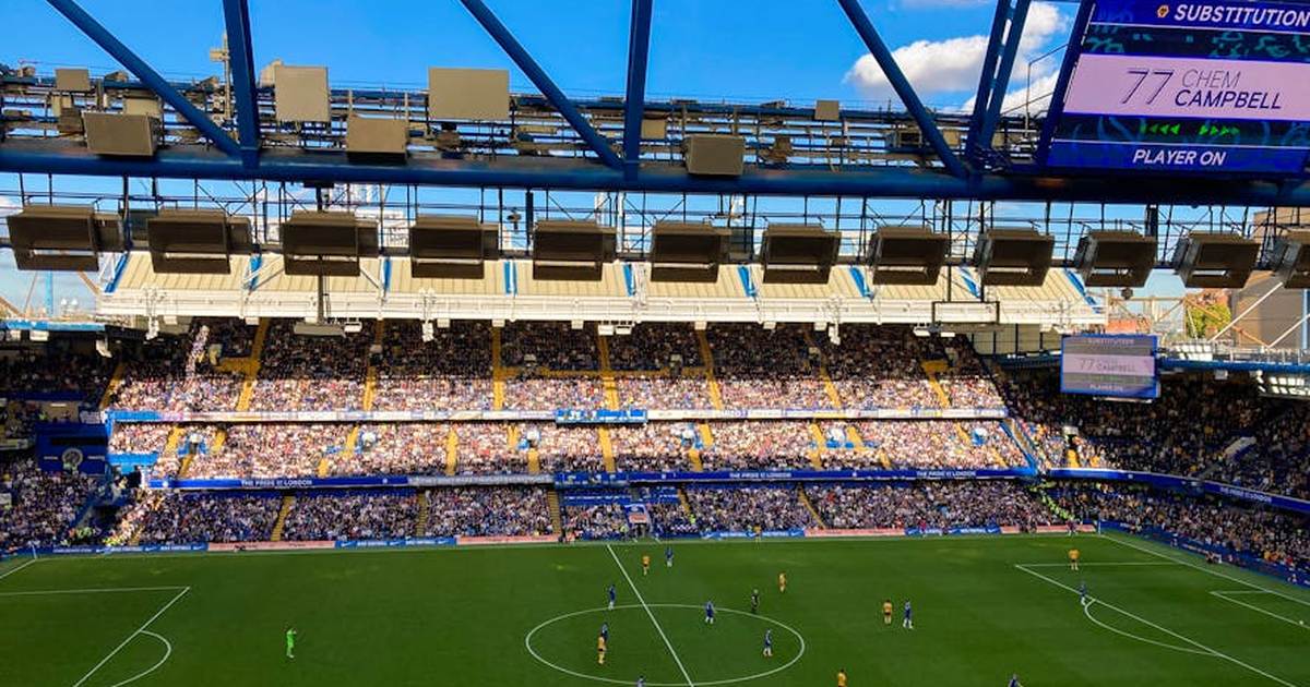 A lively football match in Stamford, England capturing the crowd and players in a filled stadium.