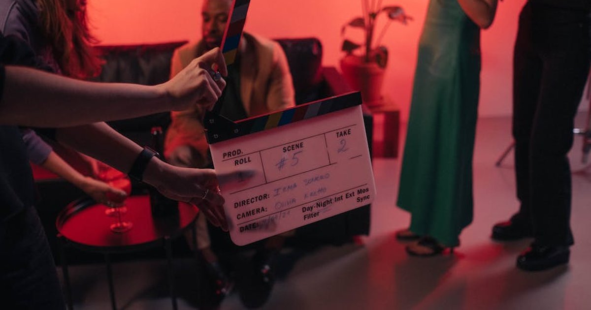 Behind the scenes of a movie set in a stylish indoor setting with clapperboard ready for action.