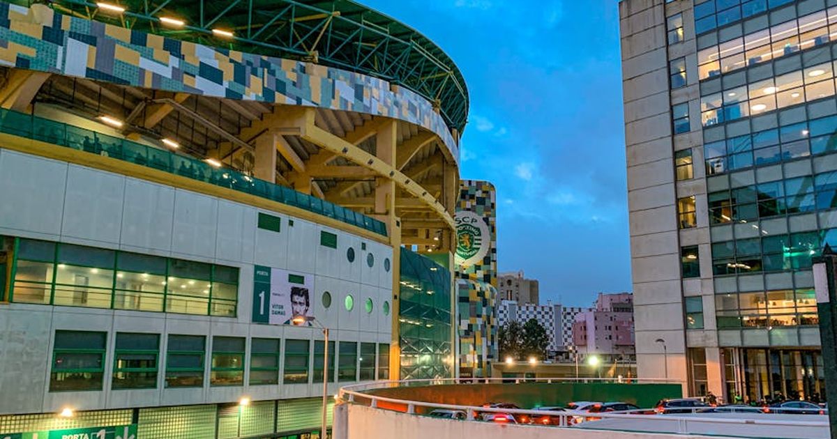 Evening view of Estádio José Alvalade in Lisbon, Portugal, showcasing modern architecture and urban scenery.