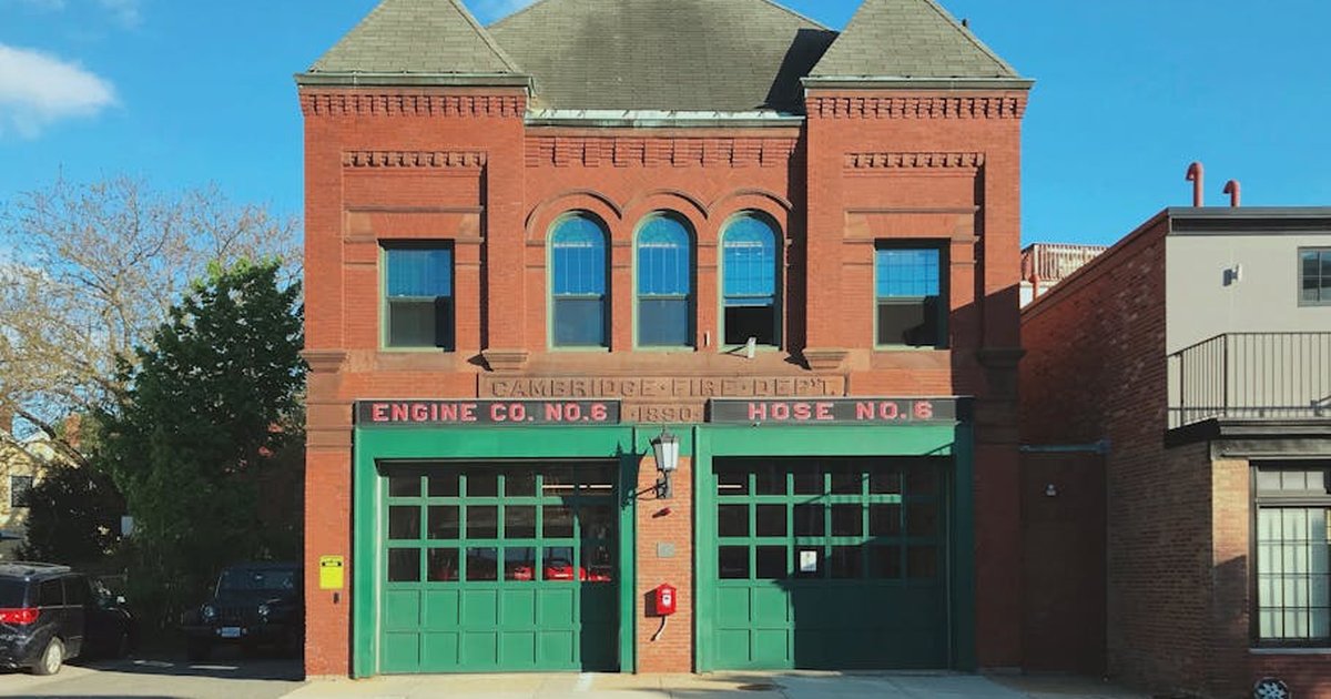 A classic red brick fire station building in Cambridge, MA, showcasing early 20th-century design.