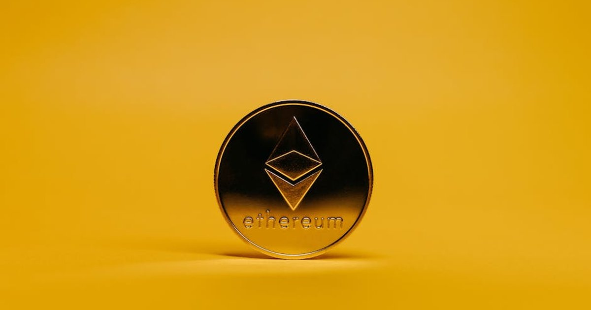 A shiny Ethereum coin displayed on a vibrant yellow background, symbolizing cryptocurrency.
