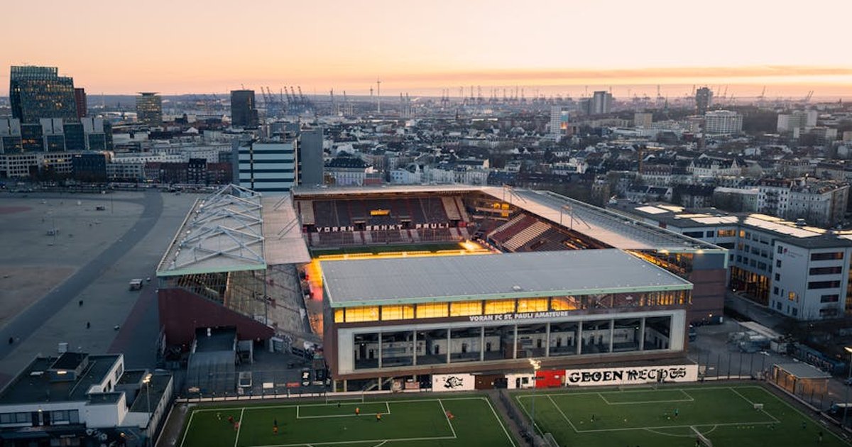 A stunning aerial shot of FC St. Pauli Stadium in Hamburg during a beautiful sunset.