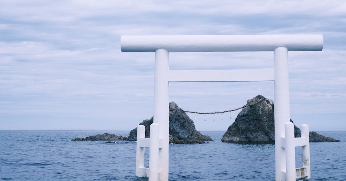 Peaceful ocean scene featuring a torii gate at Itoshima, Japan. Ideal for travel and cultural themes.