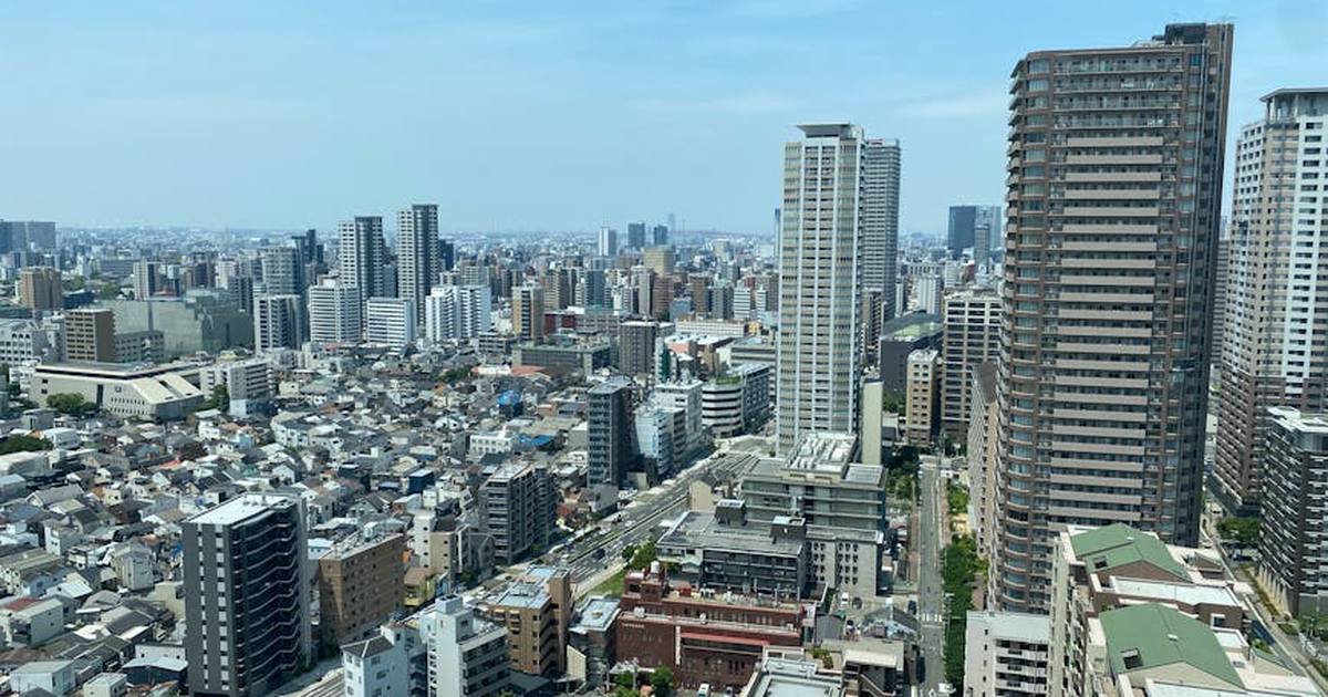 High-angle shot of Tokyo's urban skyline with skyscrapers and residential buildings.
