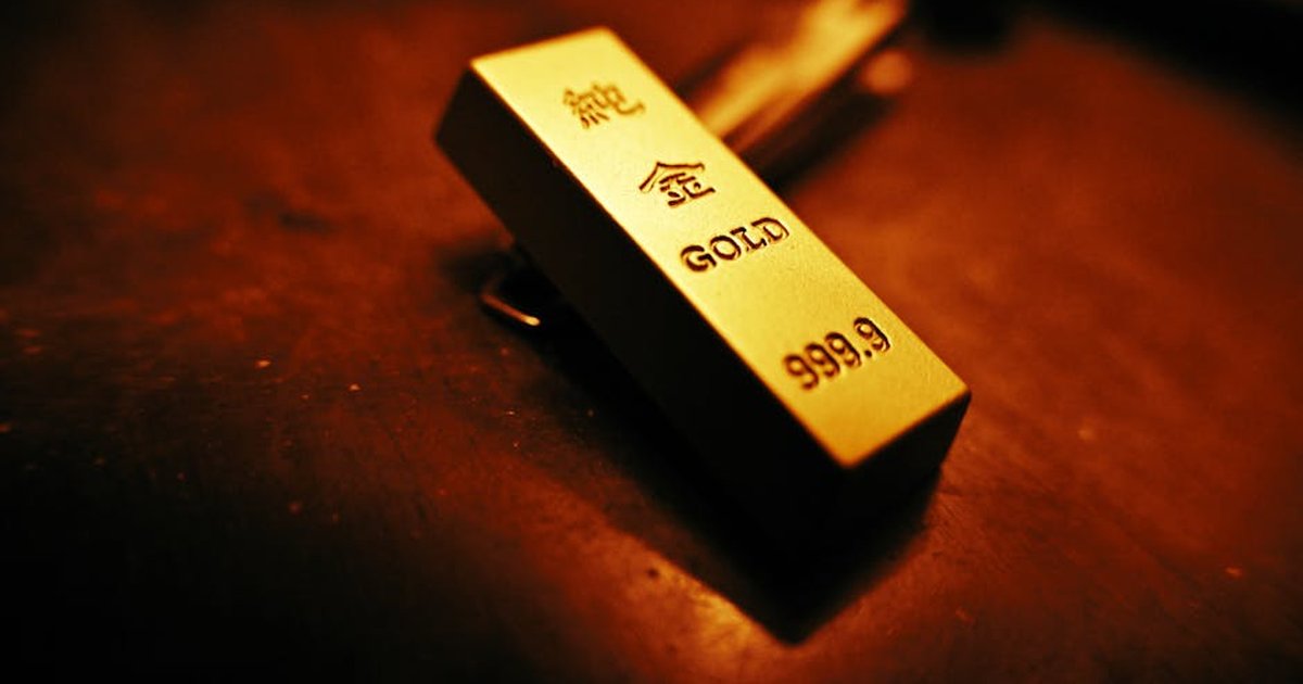 A striking close-up of a gold bar showing inscriptions, captured with warm lighting.