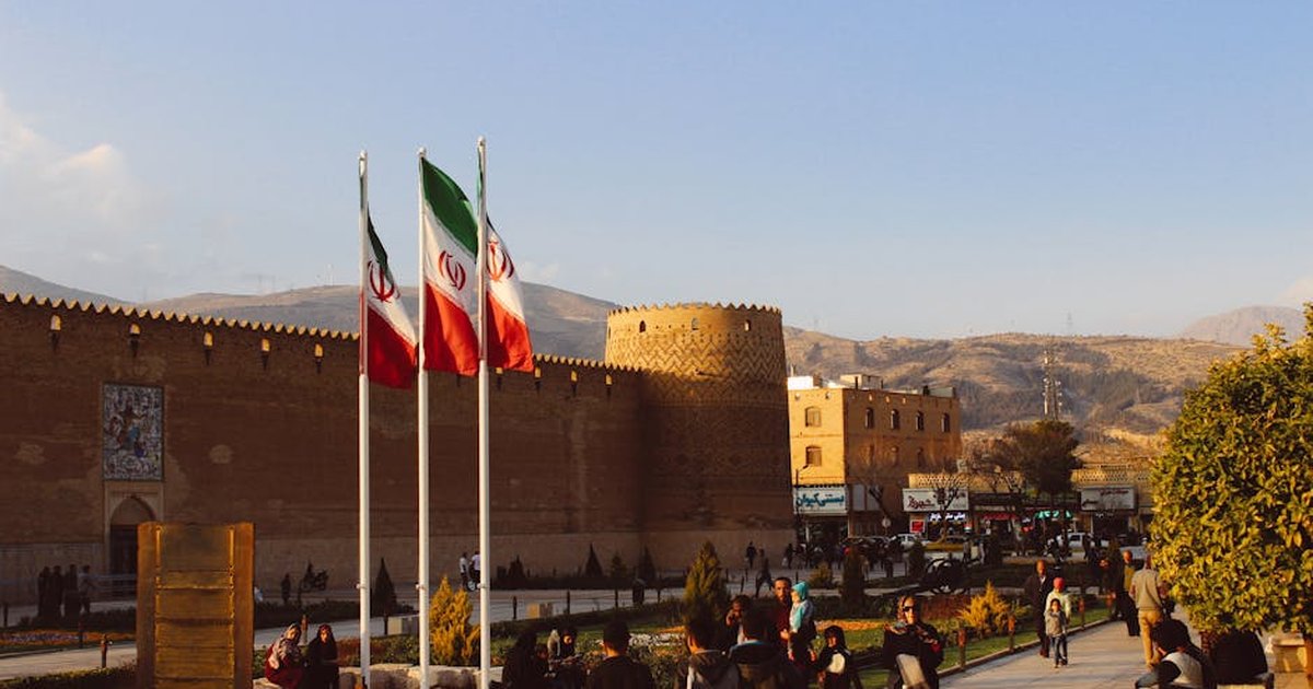 Karim Khan Citadel with Iranian flags in Shiraz, Iran at sunset.