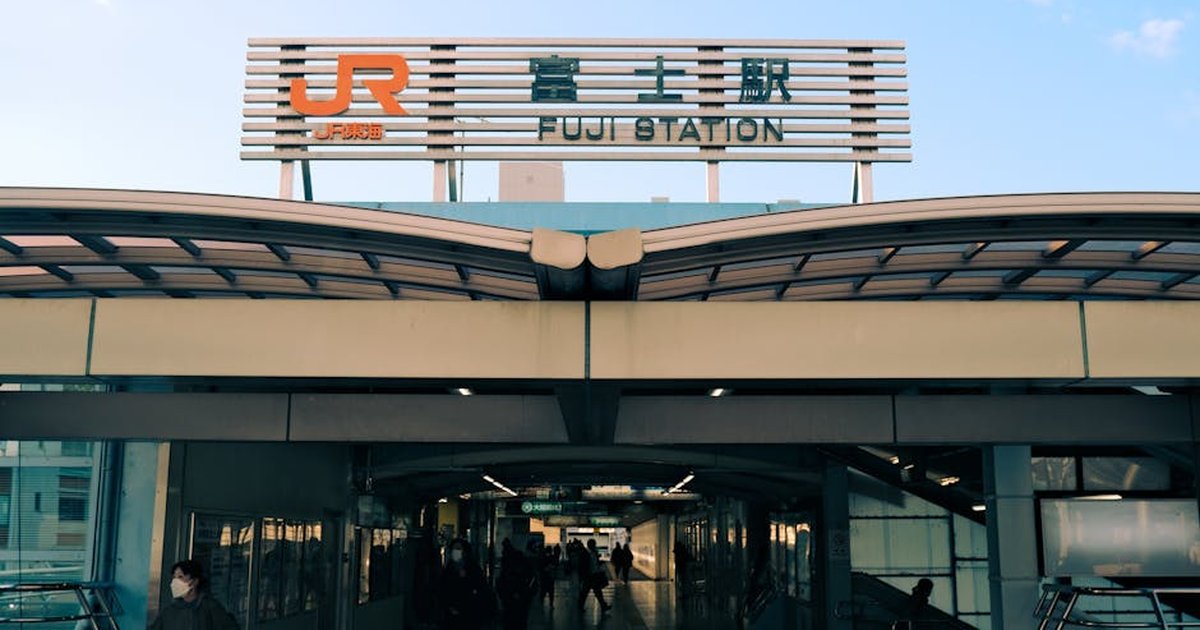 A bustling entrance to Fuji Station in Shizuoka, Japan, capturing urban transit life.