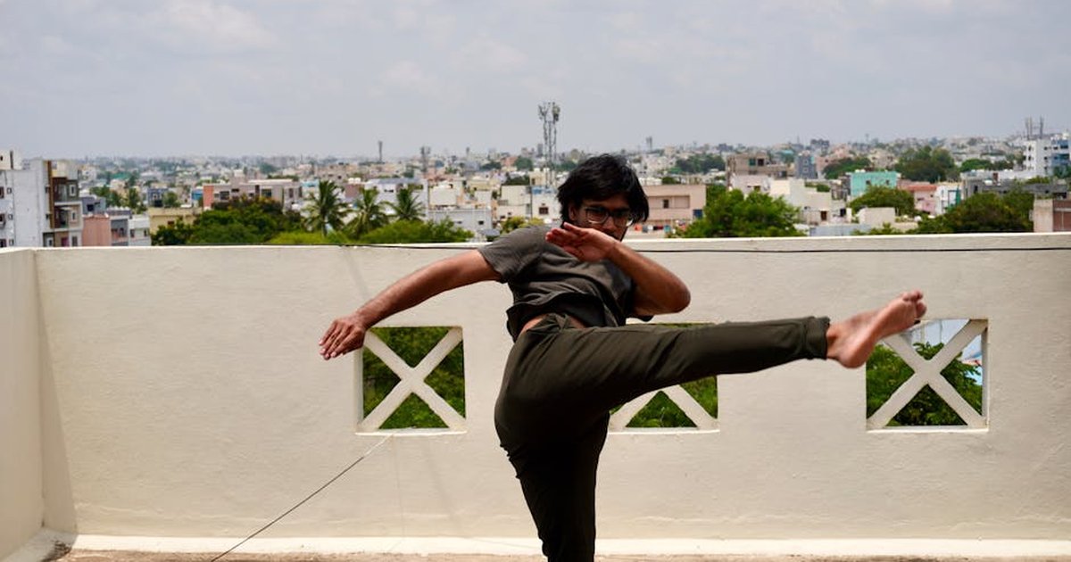 Dynamic martial arts kick captured on a rooftop in Hyderabad, India, showcasing strength and agility.