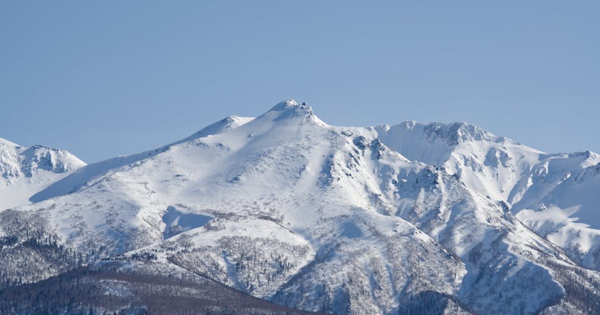 Explore the serene beauty of the snow-capped Asahi-Dake in Hokkaido, Japan.