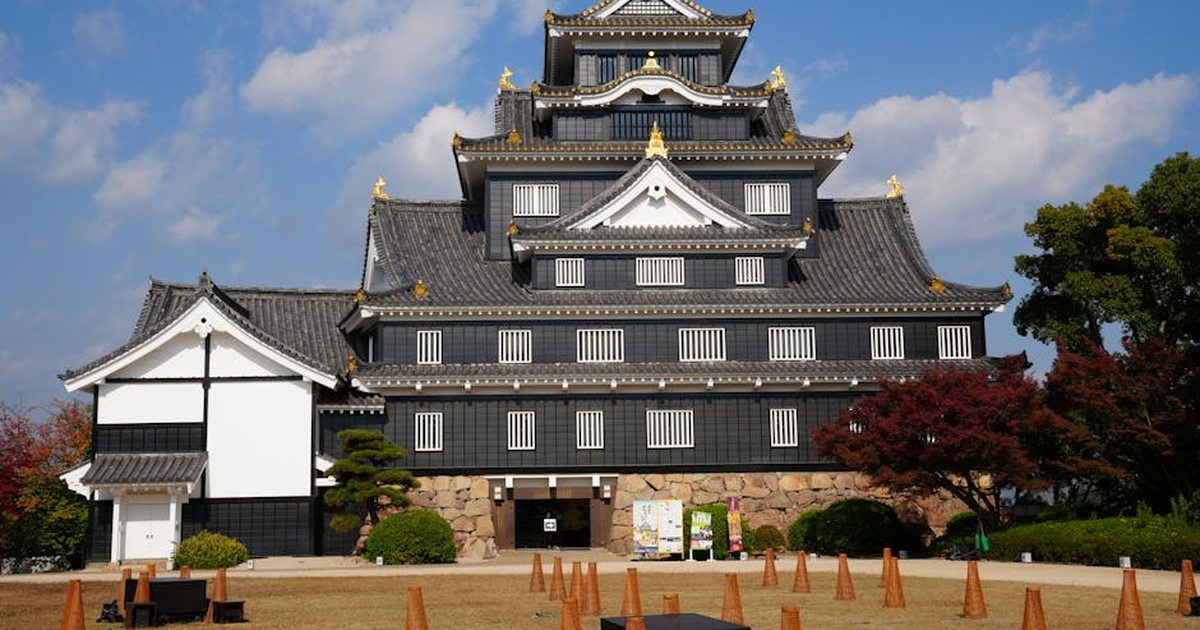 Stunning view of Okayama Castle during autumn. Clear skies enhance the beauty of its historic architecture.