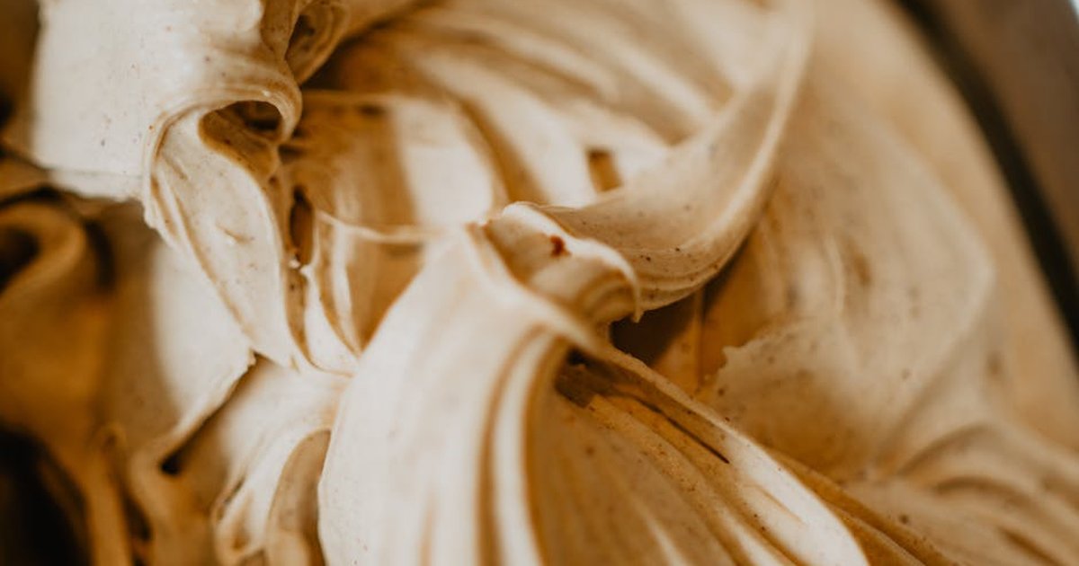Delicious creamy ice cream swirls in a close-up shot, showcasing its rich texture and inviting look.