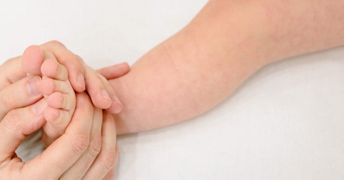 Tender infant foot massage providing soothing comfort and care.