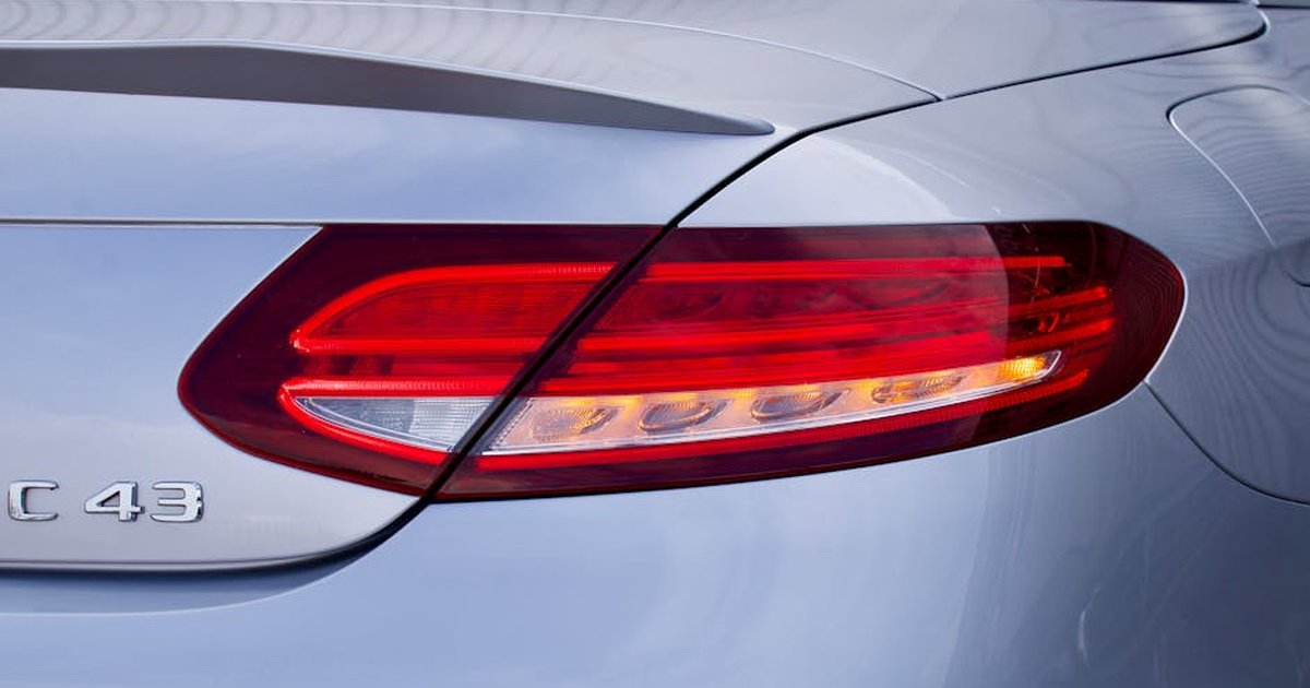 Detailed close-up of a luxury car tail light, featuring sleek design and glossy finish.