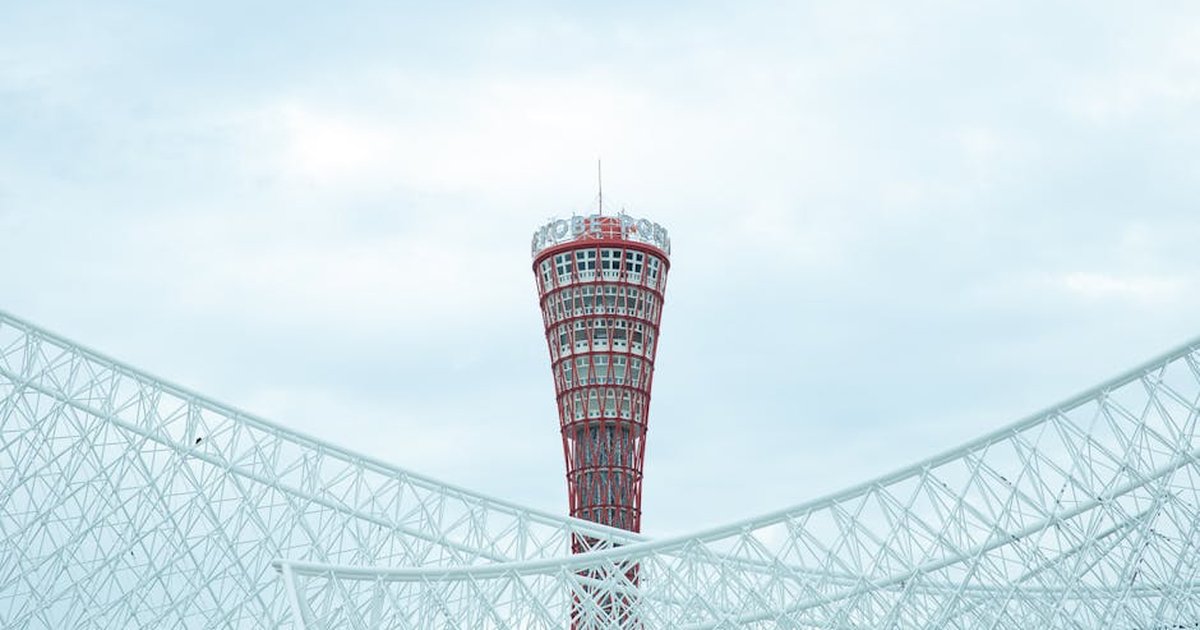 From below of tall metal tower Kobe Port Tower made in high tech architectural style