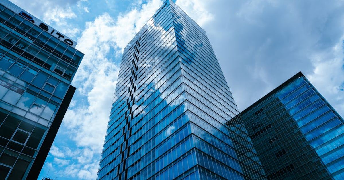 Stunning view of modern skyscrapers in Tokyo's Taito area, reflecting clouds.