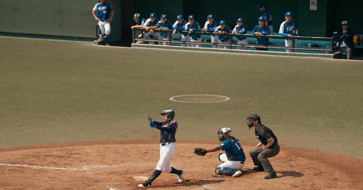 Baseball game action in Tokyo, capturing a batter, catcher, and umpire during a pitch.