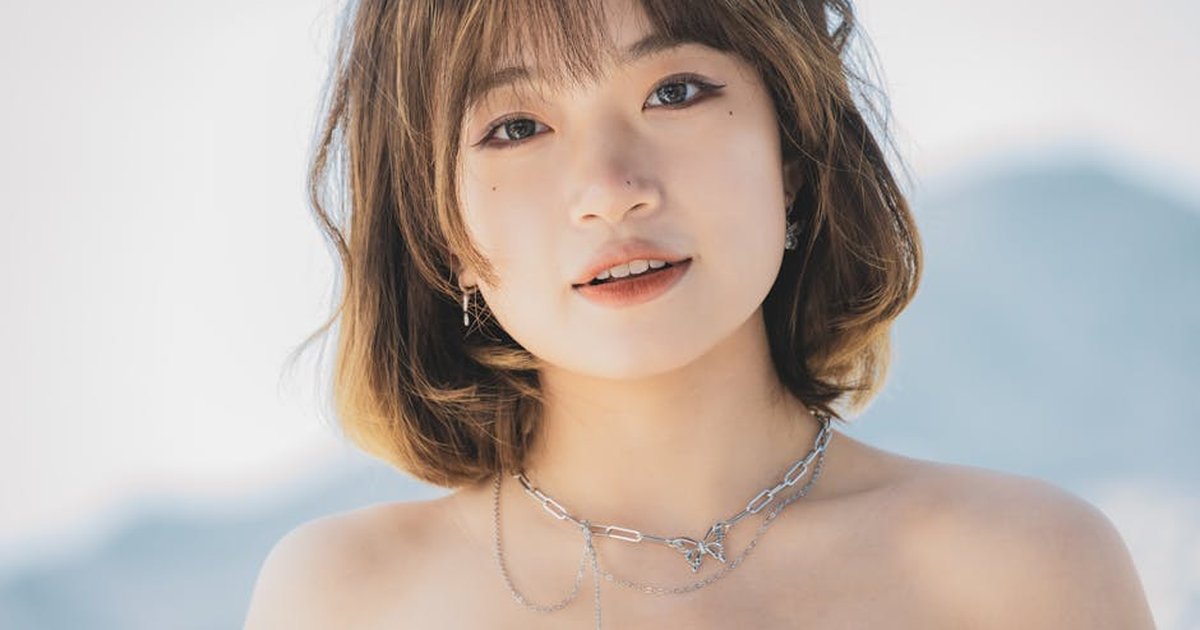 Close-up portrait of a stylish woman with necklace, outdoors in Montenegro.