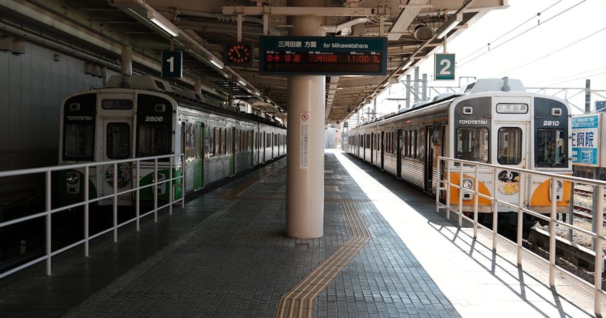 Two Toyotetsu trains at Toyohashi Station in Japan on a sunny day.