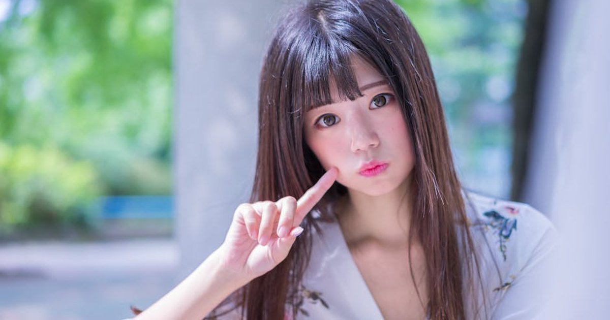 Portrait of a young Asian woman posing outdoors in Taipei's Xinyi District.