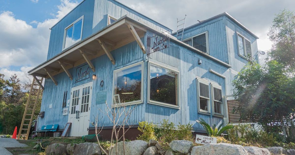 Beautiful wooden house with glass windows under cloudy sky in Itoshima, Japan.
