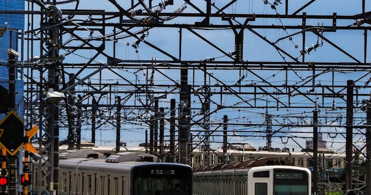 Electric trains on busy tracks in Japan, showcasing infrastructure and transportation.