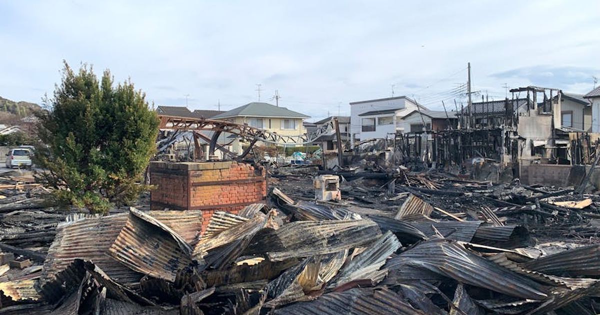 A scene showing destroyed buildings and debris after a large fire in an urban neighborhood.