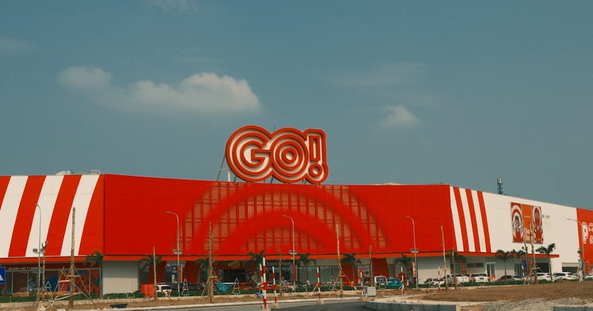 Dynamic view of the GO Shopping Center in Nam Dinh, Vietnam, showcasing its vibrant red and white facade.