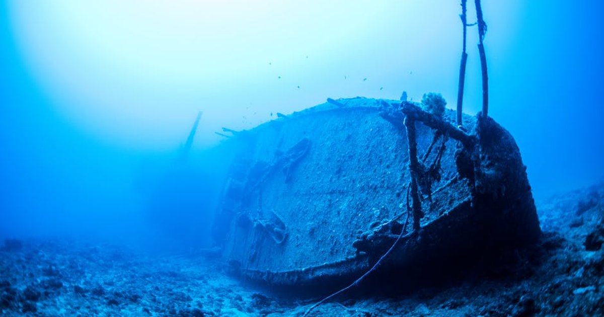 Discover the haunting beauty of a sunken shipwreck off Okinawa's coast.