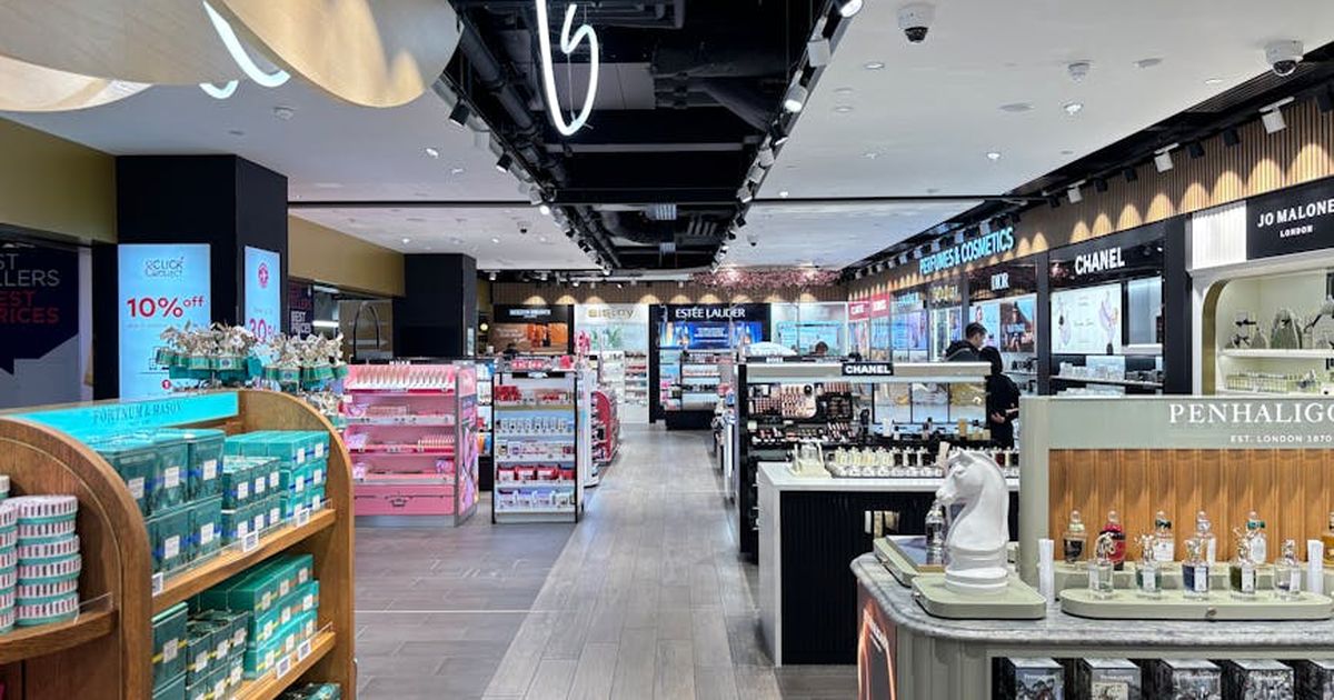 Bright cosmetics store interior showcasing luxury brands in London. Sleek and modern retail design.