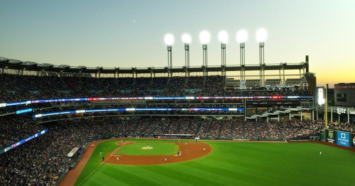 A vibrant twilight baseball game at Cleveland's Progressive Field, capturing the lively atmosphere.