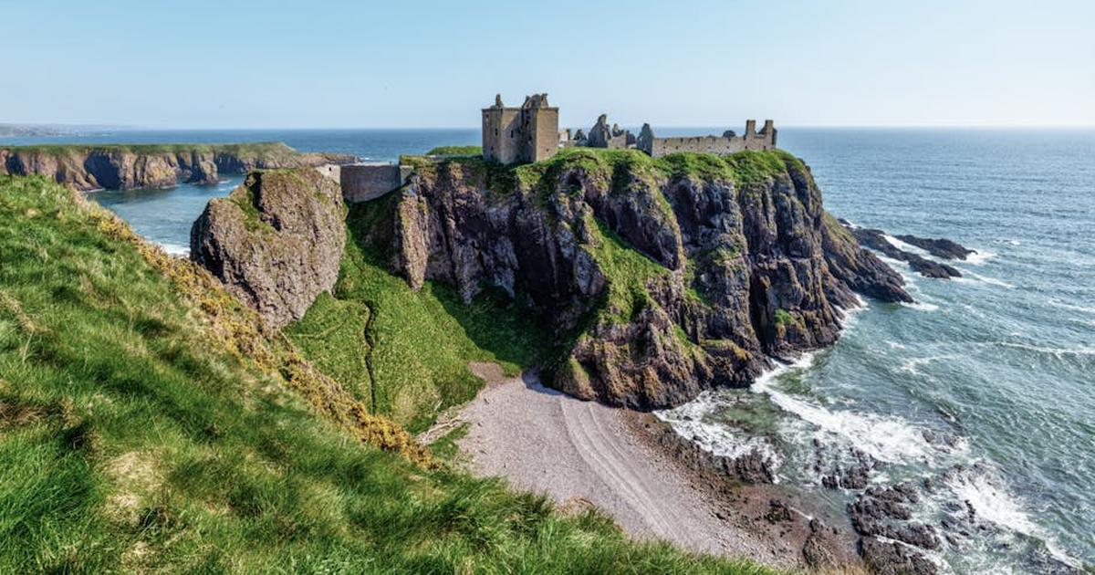 Stunning view of Dunnottar Castle perched on dramatic cliffs over the North Sea coastline.