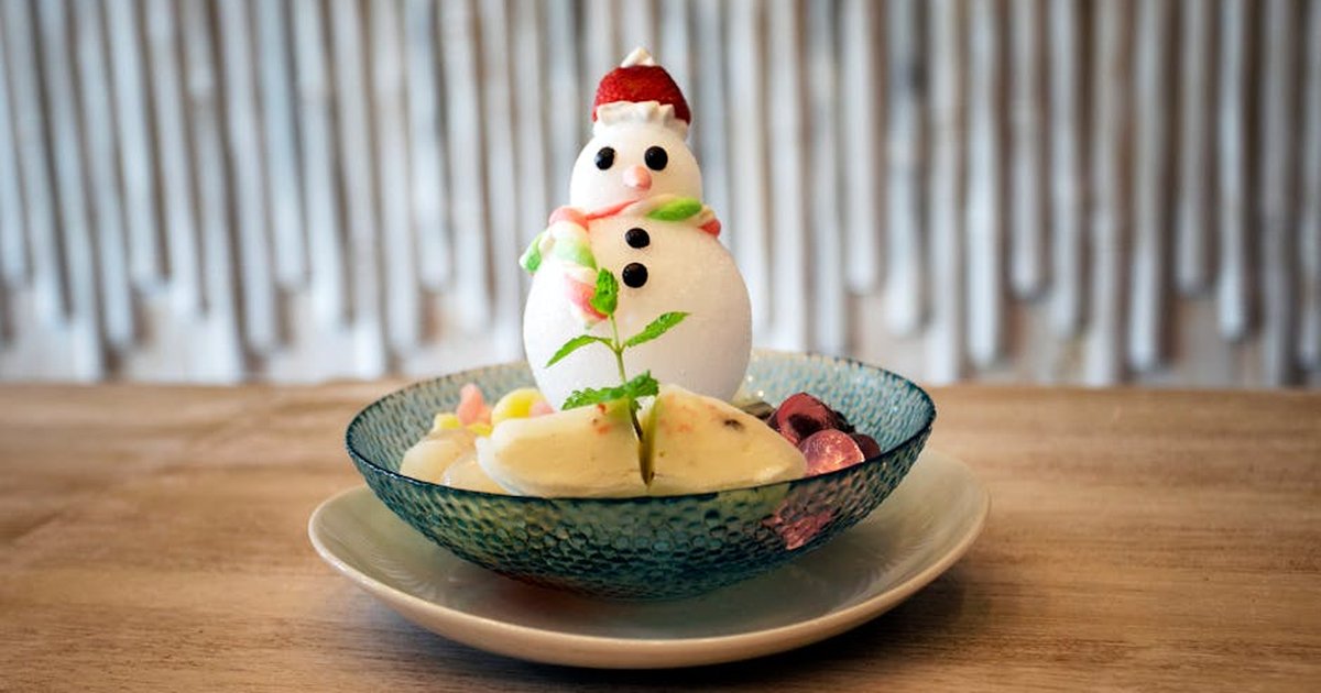 Close-up of a creative snowman dessert in a glass bowl, perfect for winter treats.