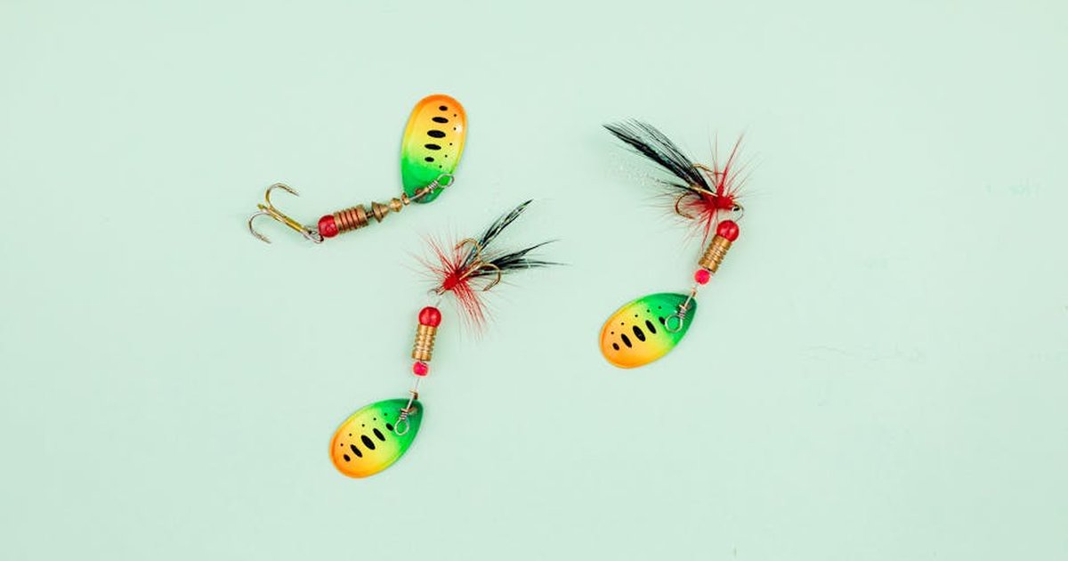 Vibrant fishing lures arranged on a pale green surface, ideal for anglers.
