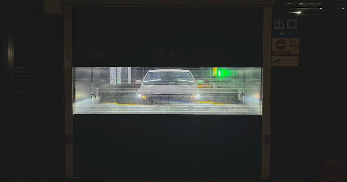 Car undergoing automatic wash in Tianjin, China, at night.