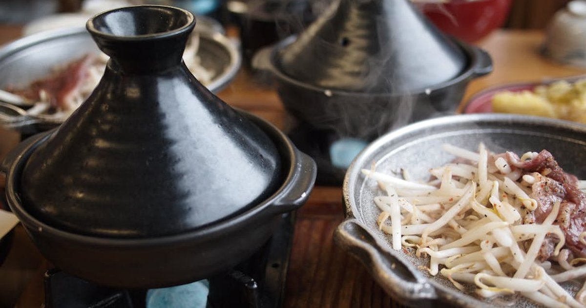 Delicious bean sprouts served in a traditional cookware setup for a warm dining experience.