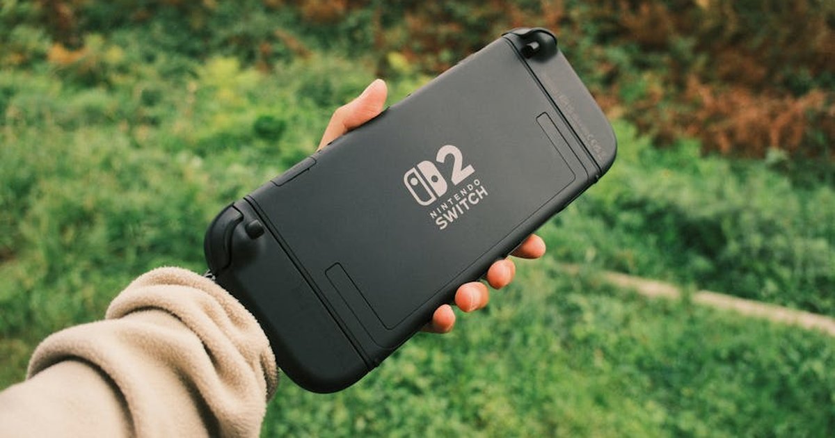 Person holding a Nintendo Switch in a natural outdoor setting, perfect for on-the-go gaming.