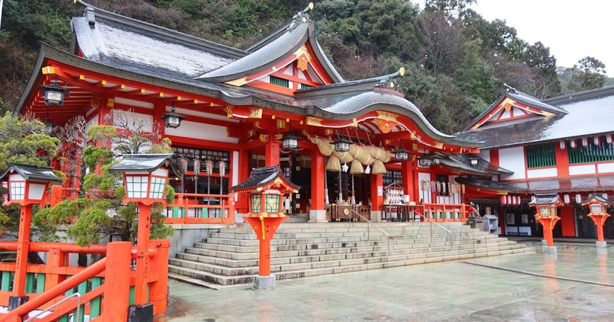 Bright red structures of Taikodani Inari Shrine in Tsuwano, Shimane, Japan set against lush greenery.