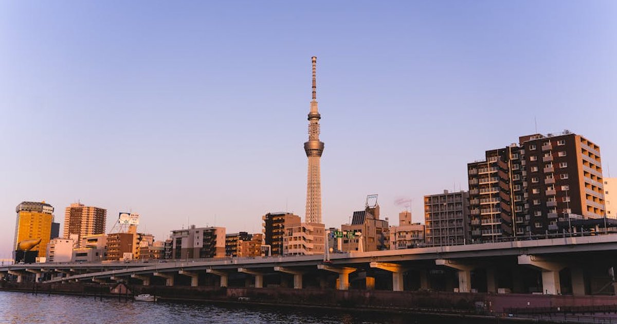 Tokyo Skytree and urban skyline at dusk along the Sumida River in Japan.