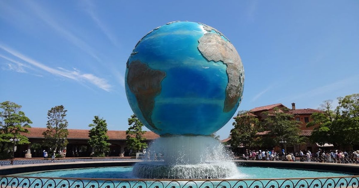 Stunning view of Earth sculpture fountain at Tokyo DisneySea under a clear blue sky.