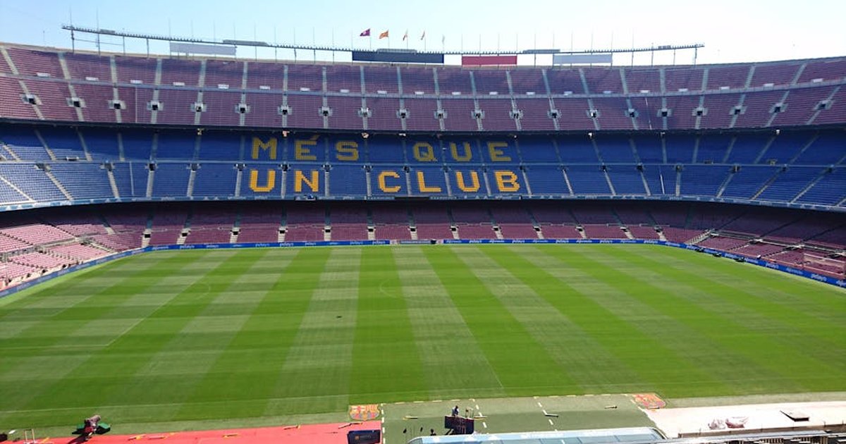 Panoramic view of Camp Nou stadium in Barcelona, home of FC Barcelona football team, with 'Mes Que Un Club' slogan.