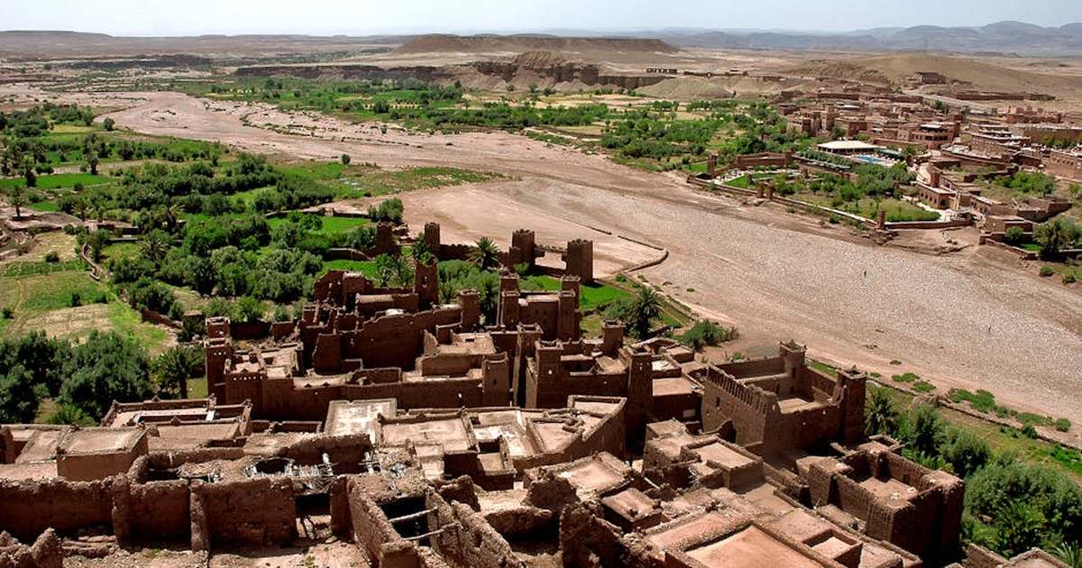Stunning aerial view of Ouarzazate's ancient kasbahs amidst lush greenery.
