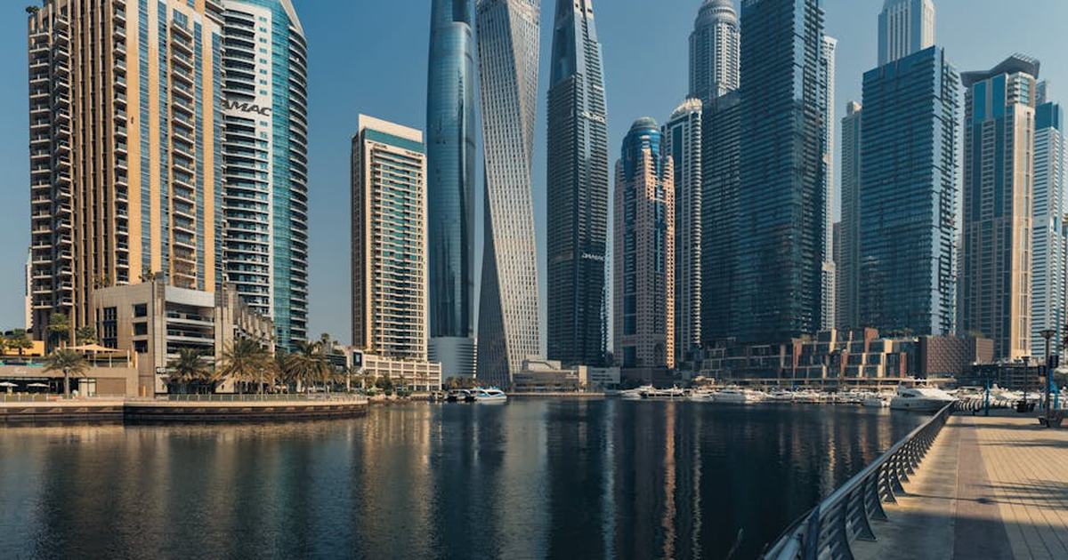 Explore the towering skyscrapers of Dubai Marina reflecting beautifully on the water.