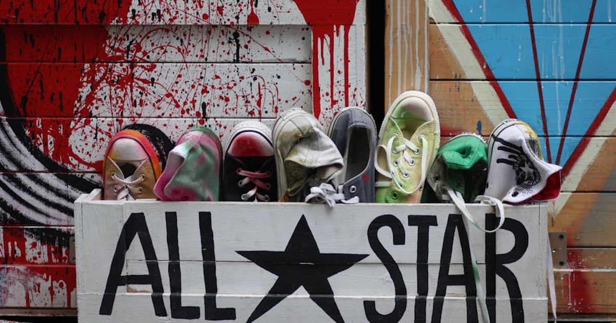 Vibrant Converse shoes displayed in a creative urban street art environment.
