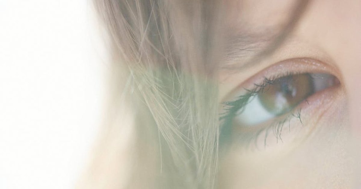 Close-up of a woman's eye with soft natural light enhancing features.