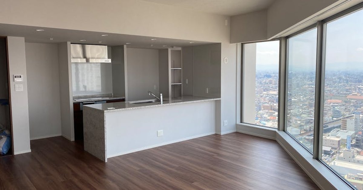 Bright and spacious high-rise apartment interior with stunning cityscape views.